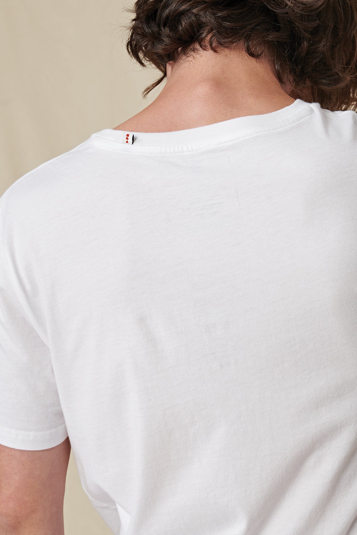 back collar view of White Globe Brand tee