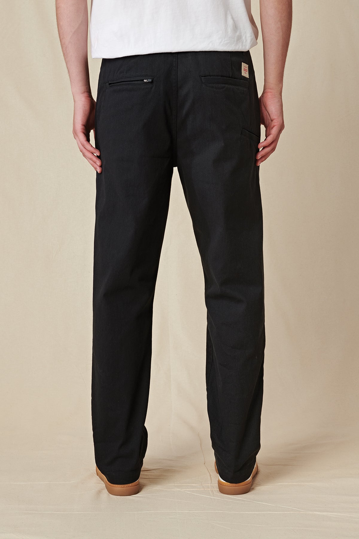 Back profile of Black Globe Pants. 