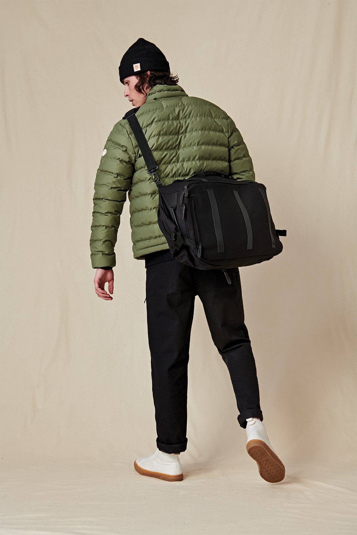 model wearing Globe Black 3 in 1 traveler bag